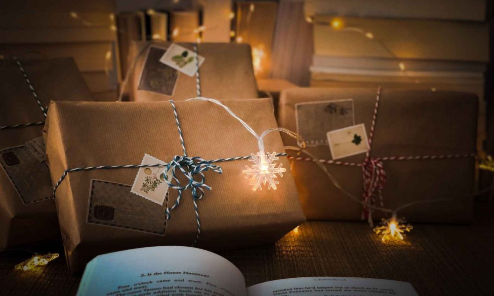 wrapped gifts kraft paper table string lights