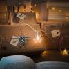wrapped gifts kraft paper table string lights